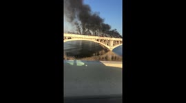 Thick smoke clouds pour from bridge in Tempe after train derails