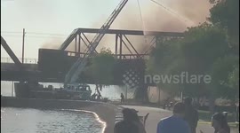 Black smoke plumes over train fire in Tempe Town Lake, Arizona