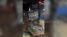 Three-storey building crashes down into construction pit in southern India