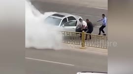 Passersby remove ill driver from burning car after crashing into guardrails in China