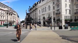 People Enjoy The Sun At London Landmarks