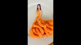 Food artist styles TikTok star Dixie D’Amelio in edible Cheetos dress