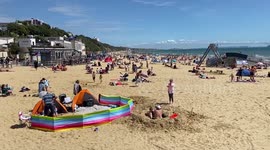 Sunseekers practice social distancing on Bournemouth beach on hottest day of the year - but councils tell people to stay away