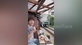 Diners Sit Next To Train Tracks At Japanese Cafe