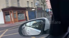 Arsenal fans on Holloway Road celebrate winning FA Cup by waving flags out of cars and beeping horns