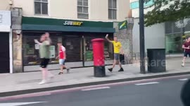 Arsenal fans on Holloway Road celebrate winning FA Cup by waving flags out of cars and beeping horns
