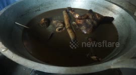 Processing cow leather results of Eid al-Adha sacrifice into traditional food