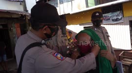 Police in Makassar, Indonesia distribute masks to residents