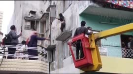 Shocking moment Indian woman threatened to jump off high ledge after alleged family dispute