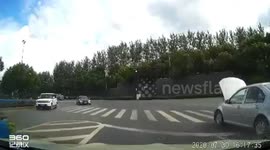 Car moves along Chinese road with bonnet open covering windscreen