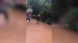 Hero soldier carries stray dog on shoulders as floods hit thousands of homes in Thailand