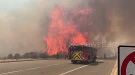 Violent flames come metres from fire truck battling brush fire in California