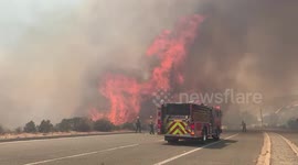 Violent flames come metres from fire truck battling brush fire in California