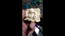 Vietnamese man sculpts buddha statue from small stone gem