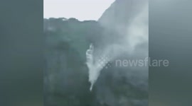 Strong winds brought by typhoon Hagupit blow waterfall up into air