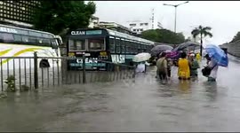 Mumbai residents forced to wade through floodwater as heaviest rainfall since 2005 strikes