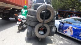 Severely Overloaded motorbikes wriggle on the streets that are congested in Vietnam