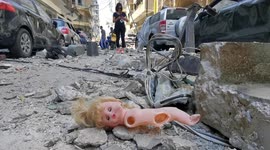 Child's doll found amongst rubble and multi-storey building hollowed out by Beirut blast