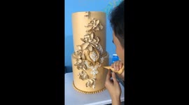 Baker decorates two-storey cake with intricate patterns