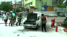 Firefighters helped avert major accident after car caught on fire in front of gas station in southern India