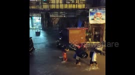Locals walk through floodwater after record rain in Mumbai, India