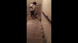 Volunteers cleaning the stairs of an devastated building