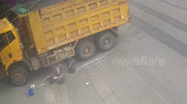 Chinese scooter rider avoids serious injury after hit by turning truck