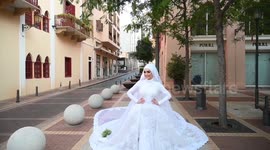 Bride poses for wedding pictures as Beirut explosion happens