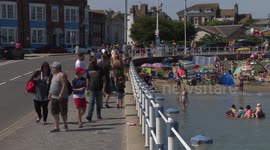 Britons flock to Weymouth beach as UK set for record-breaking heatwave
