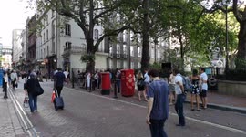 People Queue For A Drink In The August Heatwave In London
