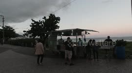 People Drinkig coconut water at Praia da Costa beach in Vila Veha