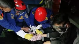 Firefighters provide assistance to a man whose finger was caught in a ring in West Jakarta, Indonesia