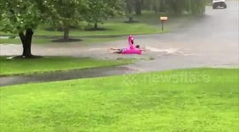 Man floats down flooded street on inflatable flamingo in New Jersey