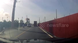 Container truck falls over while taking tight corner in Vietnam