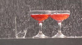 Two glasses of red wine on a wall in a thunder storm.