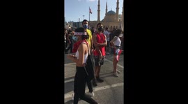 Protestors holding the picture of one of the people that died in the explosion