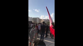 Protestors gathering rocks and throwing them