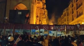 Protesters in Beirut launch projectiles over barricade leading to parliament