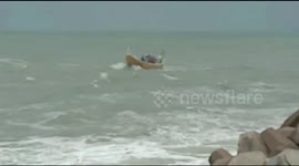 Unnerving moment two fishing boats capsize in rocky waters of southern India