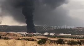 Thick plume of black smoke billows into after fire erupts at Repsol oil refinery in Spain