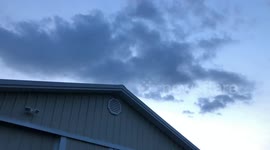 Clouds pass over barn (Broll)