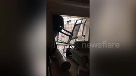 Powerful winds brought by typhoon Mekkhala blow down 27th-floor windows of building