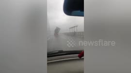 Powerful winds brought by typhoon Mekkhala blow truck container over