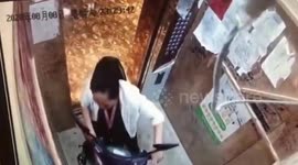 Scooter bursts into flames after Chinese woman pushes it into elevator