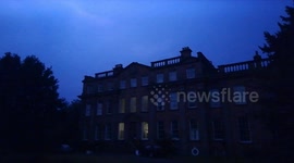 Thunder and lightning illuminate this English mansion during massive storm over central England.