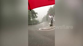 Cyclists battle through rain storm in the Dominican Republic