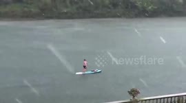UK: Man Paddleboards During The Severe Hail Storm In Twickenham, London