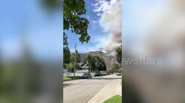 Flames tower over homes as raging brush fire spreads in Azusa, California