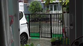 A school kid coming home from school on a wet day.