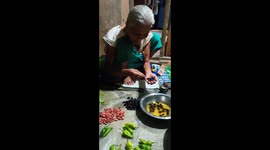 Old Grandma selling vegetables.